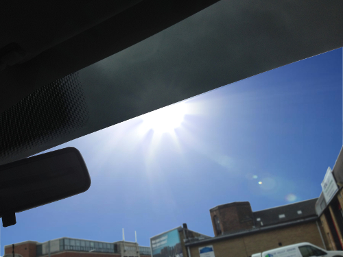 Sunstrip fitted to car windscreen to reduce glare from sun